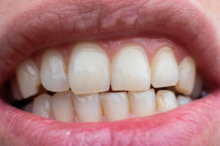 Young woman's white teeth, full mouth macro shot.の写真素材