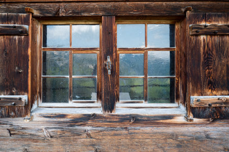 Log cabin wooden frame windows and shutters. Close up shot, Switzerland, no peopleの写真素材