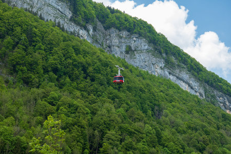 Large red funicular cabin taking tourists up the mountain in the Swiss Alps.