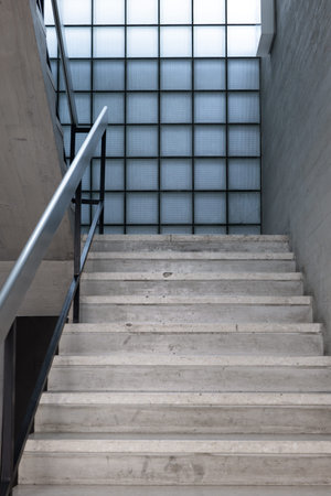 Concrete stairs in the hallway of an empty public access building. Modern architecture, bright...