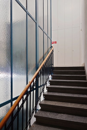 Large public building interior hallway or corridor with stairs or stairway, no people.の写真素材