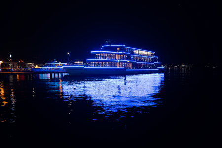 Panta Rhei passenger ship docked on lake Zurich at night, Beautiful blue lights reflected in the water.の写真素材