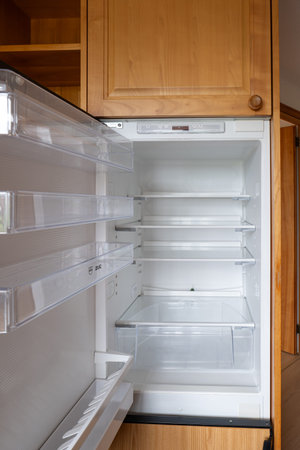 Open door home refrigerator with empty shelves, no people.の写真素材