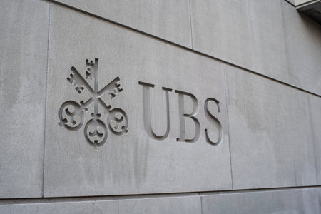 28-08-2024 Zurich, Switzerland. UBS bank writing and logo on one of the building headquarters on Bahnhofstrasse. Wide angle, exterior view, sunny summer morning, no people.のeditorial素材