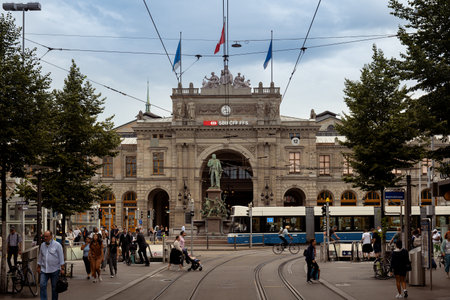 03-09-2024 Zurich, Switzerland. Zurich main train station or Hauptbahnhof as seen from the famous Bahnhofstrasse on a cloudy summer day.のeditorial素材