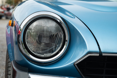 Vintage car headlight or headlamp unit. Close up shot, shallow depth of field, no people.