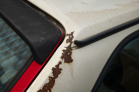 Old, rusted car body panels. Close up shot of rust patches on an old car, no people.の写真素材