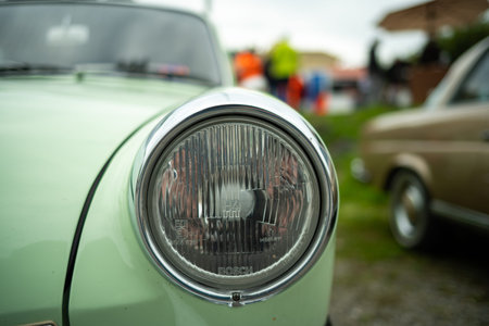 Vintage car headlight or headlamp unit. Close up shot, shallow depth of field, no people.