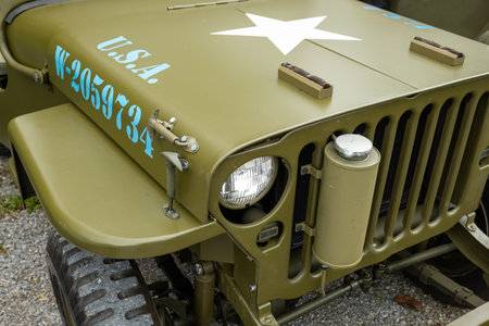6-10-2024 Zurich, Switzerland. WW2 era green, army Jeep Willys at a car show. Front, close up detail shot, no people.のeditorial素材