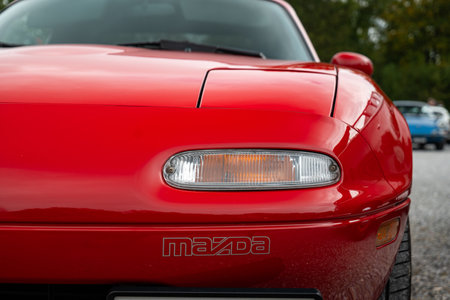 6-10-2024 Zurich, Switzerland. 1990s NA Mazda MX-5 closed headlight unit and written logo. Close up shot, shallow depth of field, no peopleのeditorial素材
