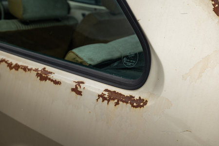 Old, rusted car body panels. Close up shot of rust patches on an old car, no people.の写真素材