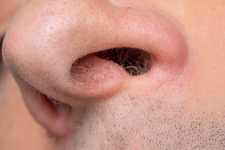Caucasian man open nose, looking up, macro close up shot, unrecognizable.の写真素材