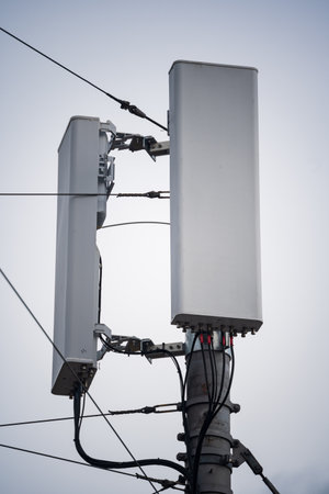 5G cell tower with signal repeaters. Close up shot, low angle, no people.の写真素材