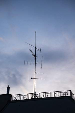 Rooftop mounted, old, TV signal capturing antenna on a residential building in Europe. Low angle view, no people.の写真素材