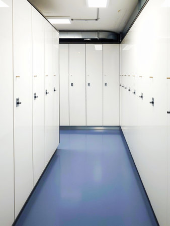 Locker room with white cabinets, wide angle shot, no people.の写真素材