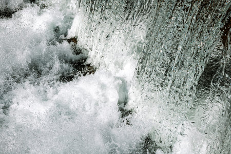 Waterfall splashing texture or background. Fast shutter speed, frozen motion, close up shot, no...