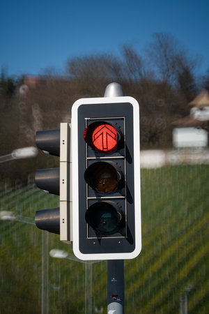 Urban traffic semaphore or stop light with illuminated red light. Looking up shot, shallow depth of field, no people.の写真素材
