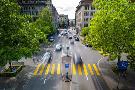 Blurred car traffic above point of view. Daytime long exposure of heavy traffic on a 4 lane city street in Europeの写真素材