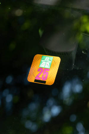Swiss highway driving permit sticker, stuck on a car's windshield. Close up shot, driving in Switzerland concept, no peopleの写真素材