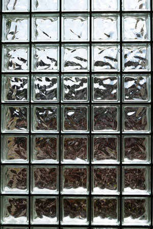 Opaque glass bricks wall with sunlight shinning through, wide angle, no peopleの写真素材