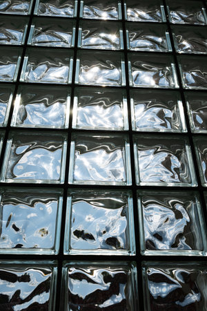 Opaque glass bricks wall with sunlight shinning through, wide angle, no peopleの写真素材