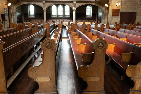 Empty church pews inside protestant church in Europe. Wide angle view, natural window light, no peopleの写真素材