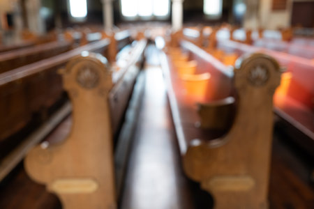 Blurred image of empty pews inside protestant church in Europe. Wide angle view, natural window light, no peopleの写真素材