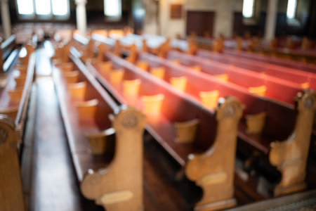 Blurred image of empty pews inside protestant church in Europe. Wide angle view, natural window light, no peopleの写真素材