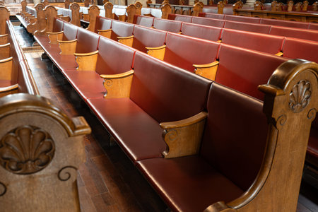 Empty church pews inside protestant church in Europe. Wide angle view, natural window light, no peopleの写真素材