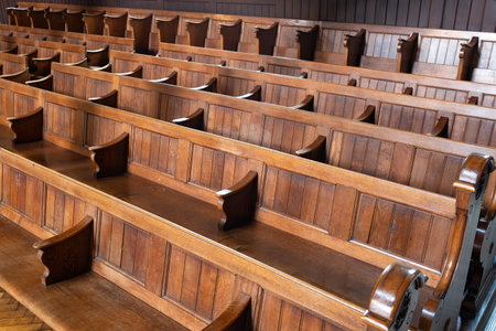 Empty church pews inside protestant church in Europe. Wide angle view, natural window light, no peopleの写真素材