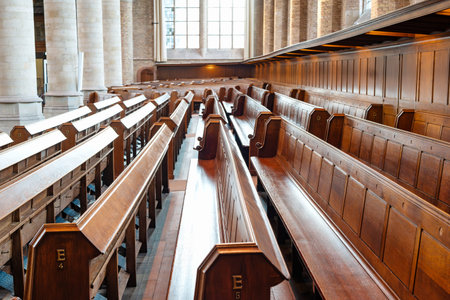 Empty, wooden church pews or benches inside protestant church, no people