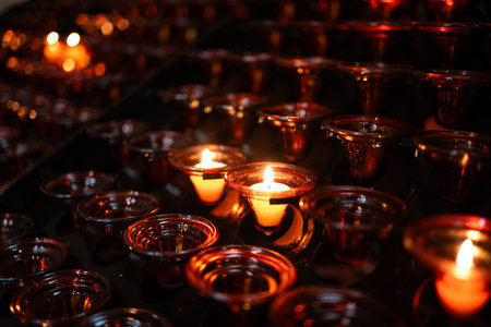 Group of burning small candles inside church, no peopleの写真素材