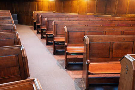 Empty, wooden church pews or benches inside protestant church, no people