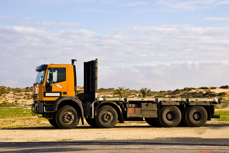 Picture of a  delivery cargo vehicle without a box parked on the shoulders