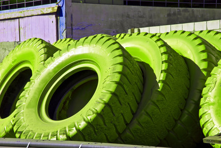 Worn tires of huge industrial cars colored in green.の写真素材