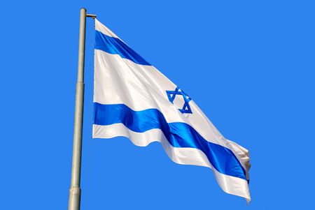 A waving Israeli flag against the blue sky backgroundの写真素材