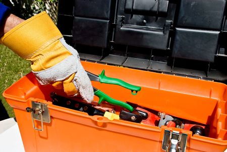 Worker's hand taking snips out of a toll boxの写真素材