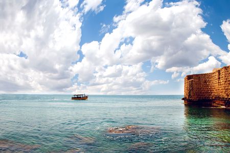 A small pleasure boat goes to the ancient fortress の写真素材