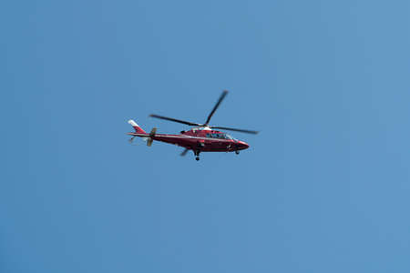 Helicopter flying in blue skyの写真素材