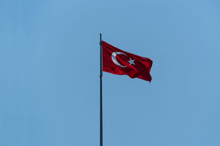 Turkish flag in blue sky backgroundの写真素材