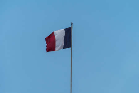 French flag in blue sky backgroundの写真素材