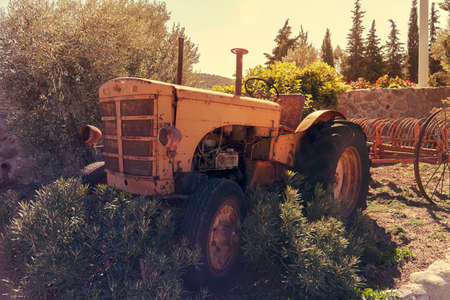 Old vintage tractor in a farmの写真素材