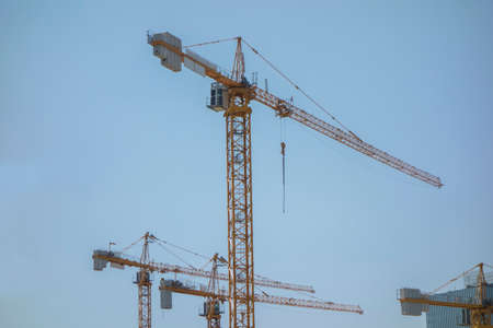 blue sky and yellow construction equipmentの写真素材
