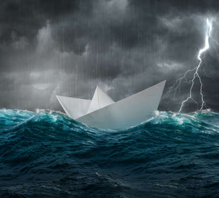 stormy sea and paper shipの写真素材