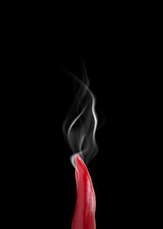 hot pepper with smoke on black backgroundの写真素材