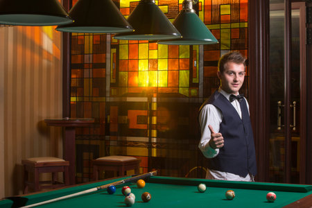 handsome man playing billiard