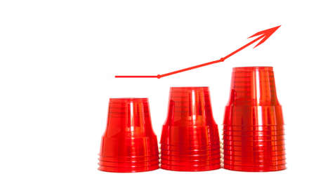 Concept of rising plastic consumption. Red plastic cups, isolated backgroundの写真素材