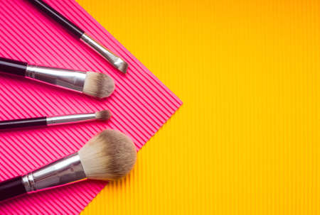 Set of makeup brushes against multicolor trendy background. Top view point, flat lay.の写真素材
