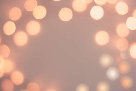 Abstract pastel blurred golden sparkling festive bokeh backgroundの写真素材