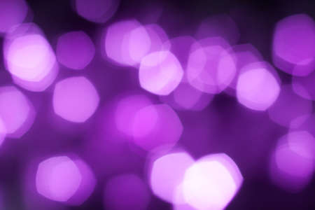 Abstract blurred purple sparkling festive bokeh backgroundの写真素材